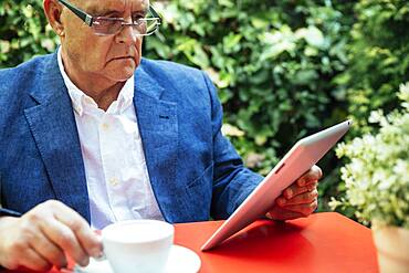 Hispanic businessman using digital tablet