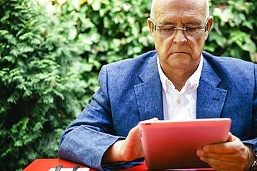 Hispanic businessman using digital tablet