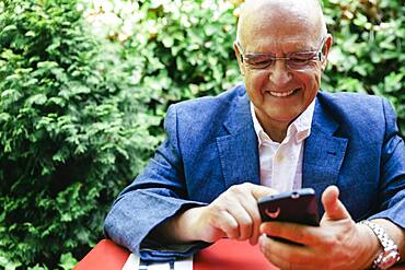 Hispanic businessman using cell phone