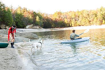 Couple kayaking in remote lake