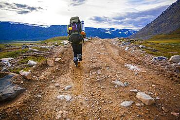 Mari backpacker walking on dirt path