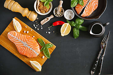 Raw salmon on cutting board with ingredients