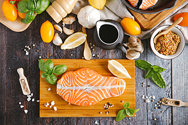 Raw salmon on cutting board with ingredients