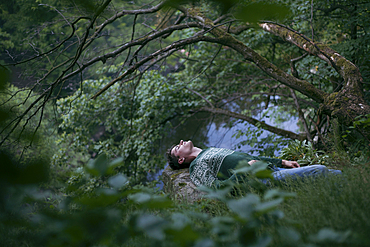 Caucasian man relaxing in woods