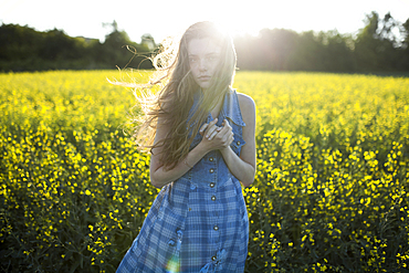 Portrait of Caucasian woman standing in windy field