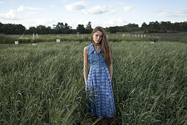 Portrait of Caucasian woman standing in field on farm