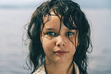 Caucasian girl with wet hair near lake