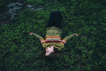 Caucasian woman laying in grass