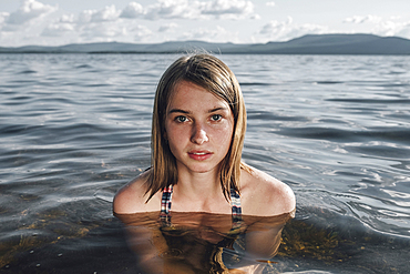 Serious Caucasian woman swimming in ocean