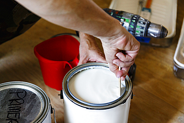 Hand of native American woman stirring paint