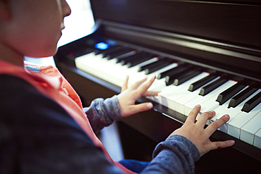 Hispanic boy playing piano