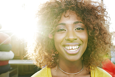 Sun beams on face of smiling black woman