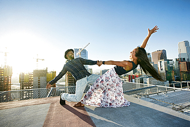 Couple dancing on urban rooftop