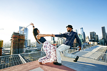 Couple dancing on urban rooftop