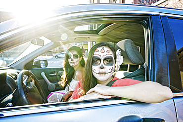 Women in car wearing skull face paint