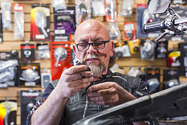 Caucasian man repairing motorcycle