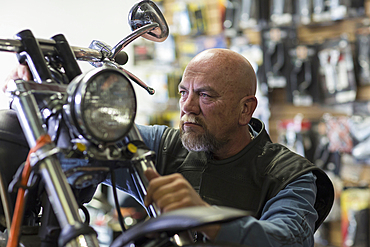 Caucasian man repairing motorcycle