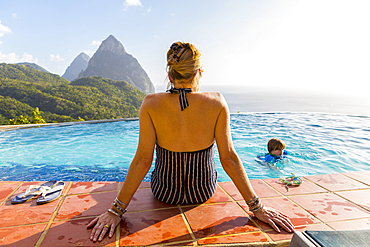 Caucasian mother watching son swimming