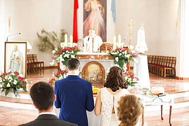 Couples waiting in church