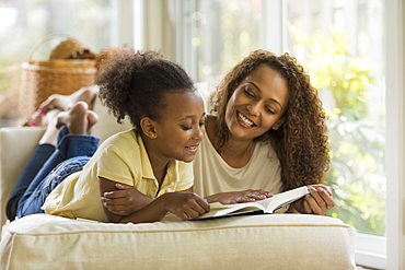 Mother and daughter reading book