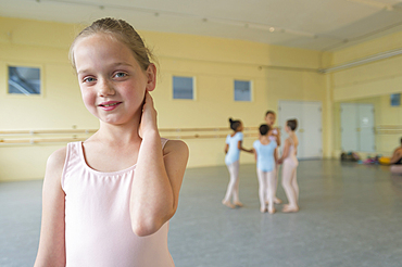 Portrait of smiling girl in ballet studio