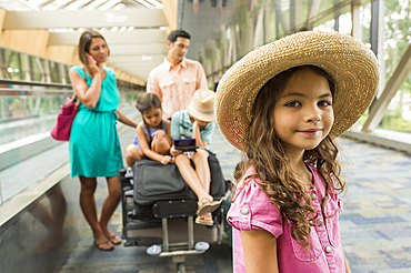 Portrait of girl waiting in airport with family