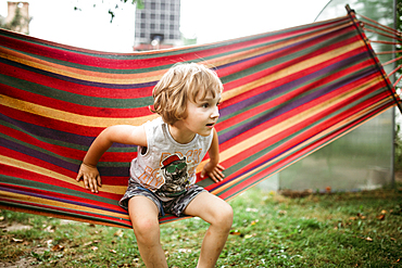 Caucasian boy sitting in hammock