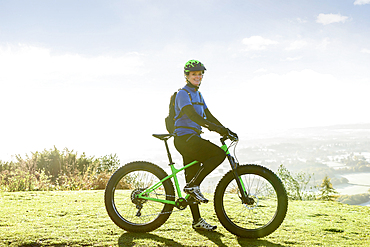 Portrait of smiling Caucasian woman riding bicycle