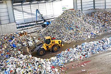 Bulldozer pushing pile of trash