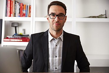 Portrait of smiling Caucasian businessman in office