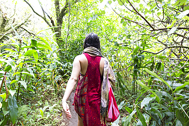 Caucasian woman walking in forest