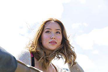 Wind blowing hair of Mixed Race woman