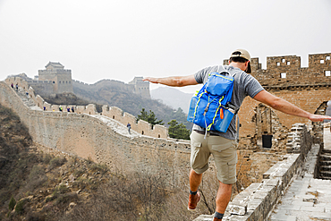 Tourist balancing on Great Wall of China, Beijing, China