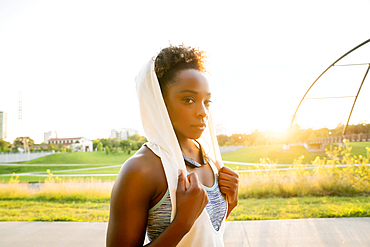 Mixed race woman resting with towel on head