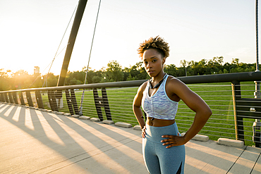 Mixed race woman resting on bridge