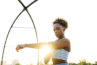 Portrait of mixed race woman stretching arms