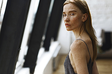 Close up of serious Caucasian woman with freckles