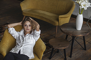 Portrait of Caucasian woman sitting in armchair