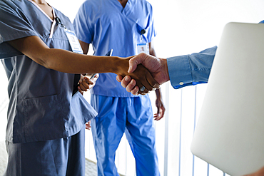 Doctor and nurse shaking hands