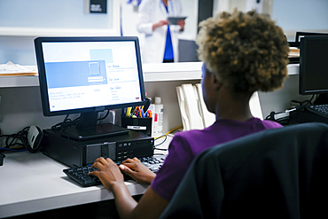 Nurse using computer in hospital