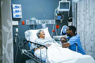 Nurse talking to patient in hospital bed