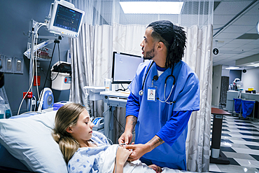 Nurse placing finger monitor on patient