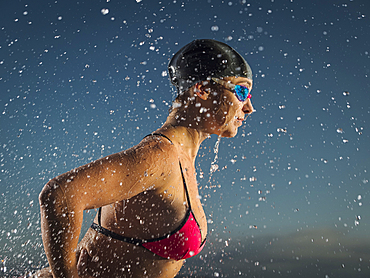 Water splashing on Caucasian swimmer