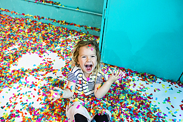 Colorful confetti falling on Caucasian girl