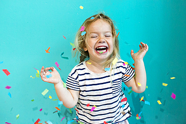 Colorful confetti falling on Caucasian girl