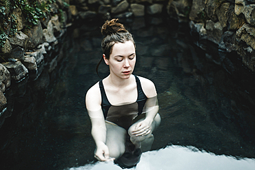 Caucasian woman swimming in pond