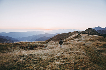 Caucasian man hiking in remote mountain landscape