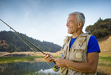 Caucasian man fishing at river