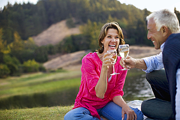 Couple toasting with wine and laughing