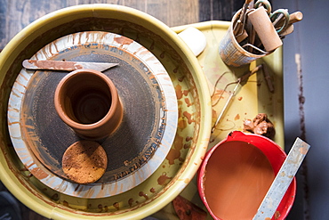 Cup and tools on pottery wheel